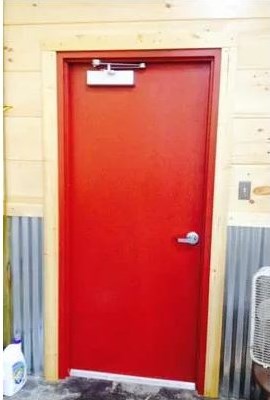 Red commercial metal door with closer and lever handle