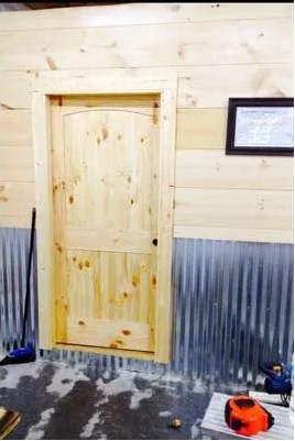 Wood door with arched panel in a workshop display
